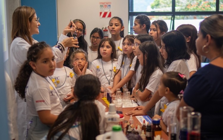 Niñas en el laboratorio de química viendo experimentos.