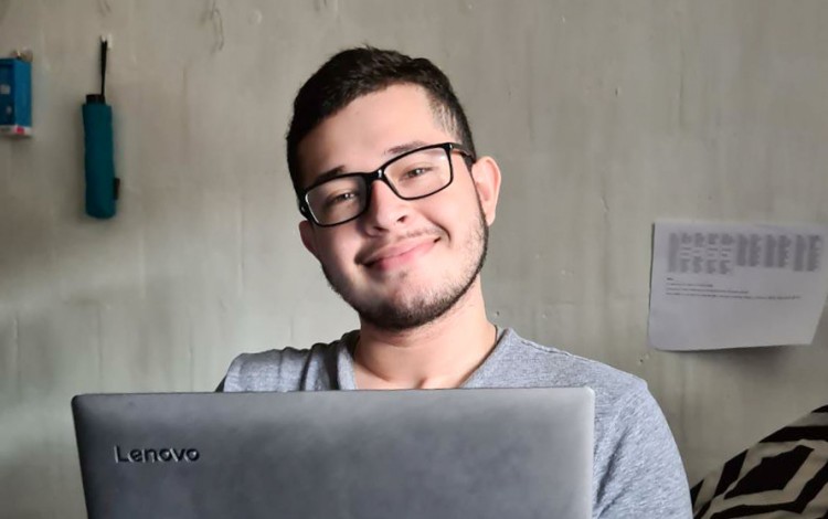 imagen de un estudiante con una computadora en sus manos.