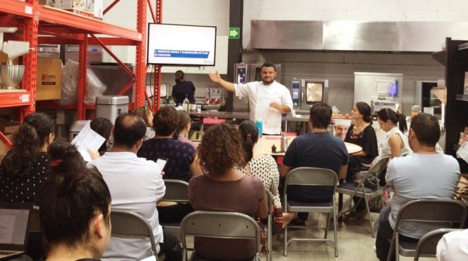Un grupo de personas atiende a las lecciones de un chef.