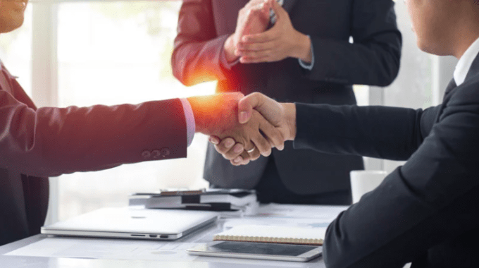 Imagen ilustrativa sobre dos personas dándose la mano, como señal de trato. 