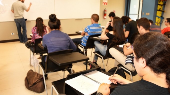 imagen de varios estudiantes en en aula recibiendo lecciones.