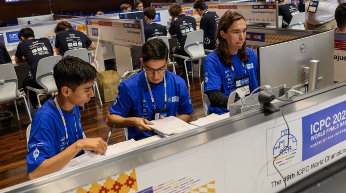 Imagen de tres estudiantes en la competencia.