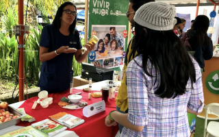 imagen de una mujer mostrando productos saludables a los estudiantes del TEC.