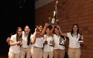 Seis mujeres levantan un trofeo.