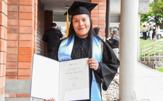 Joven indígena posa el su título para la fotografía. 