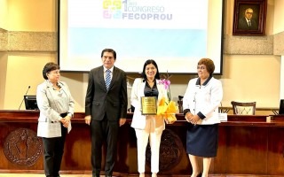 Imagen de cuatro personas posando para la foto. Momento de la entrega del reconocimiento a la Rectora del TEC.