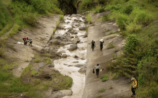 Imagen de varias personas recolentando basura del Río Torres.