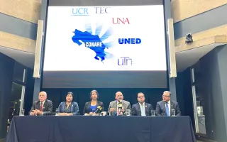 Rectores y rectora con una proyección de los logos de las universidades